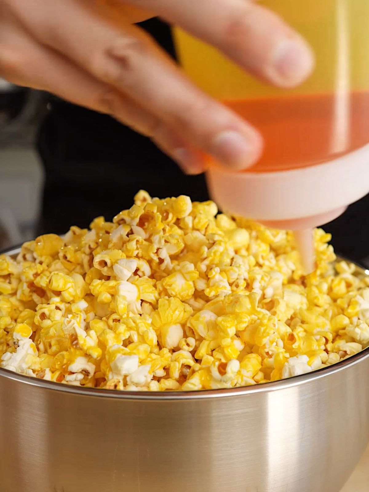 pouring butter flavored coconut oil on Movie Theater Popcorn Recipe