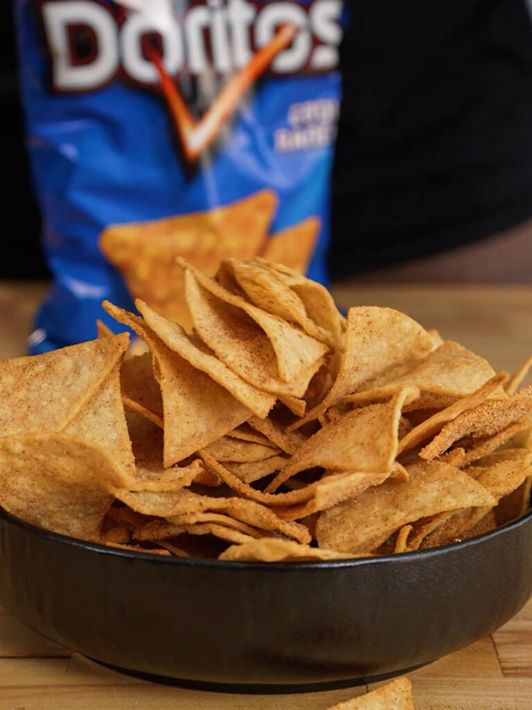 A full bowl of the finished, perfectly seasoned homemade Cool Ranch Doritos recipe chips.