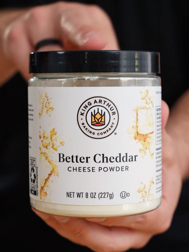 A jar of King Arthur Better Cheddar Cheese Powder, used by food scientist Roice Bethel (@noflakeysalt) to add flavor complexity to his cheese dust copycat.