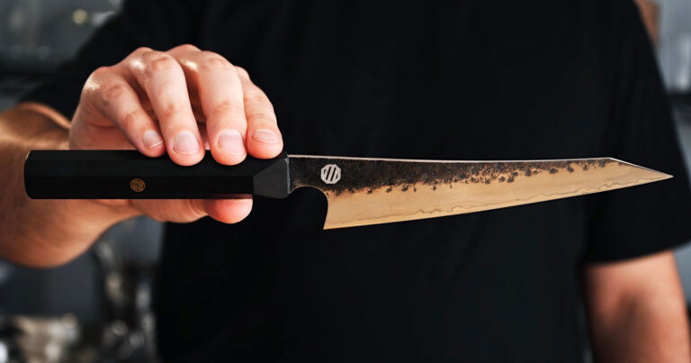 Hands holding a Majime Meraki knife, ready for the best knife sharpening equipment